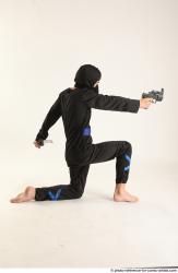 Man Young Athletic Fighting with gun Kneeling poses Casual Asian